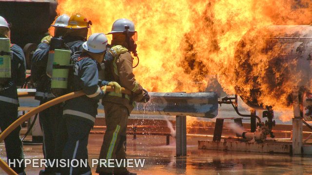 Fire Crew Tackling Flames at a Training Rig