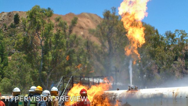 Fire Training with Flames Along a Tank - Portrait