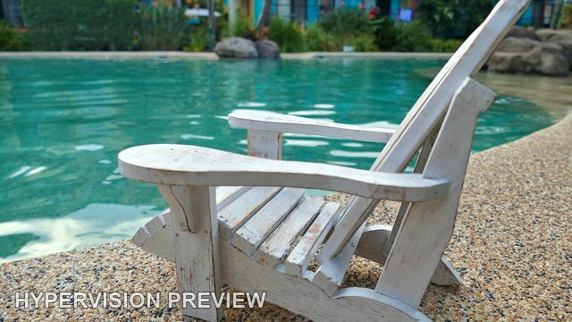 White Miniature Chair Beside a Pool - Side View