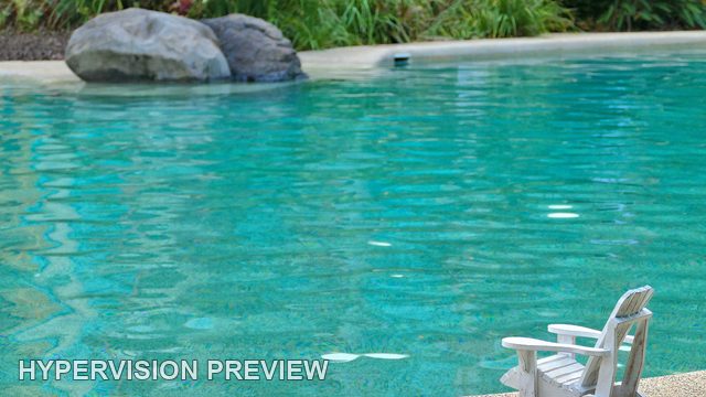 Tiny White Chair and a Broad Pool Setting