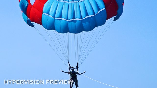 Parasail Riders Beneath a Cropped Canopy
