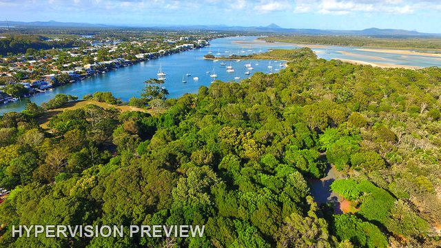 Anchored Yachts Beyond a Wooded Foreshore