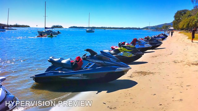 Colourful Jet Skis Lined Up on the Sand
