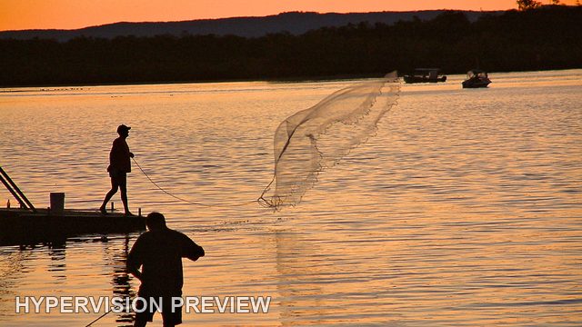 Casting a Net from a Jetty in Golden Light