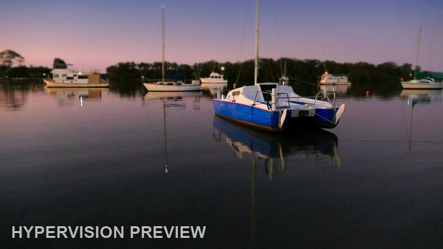 Blue and White Catamaran Reflected at Dusk
