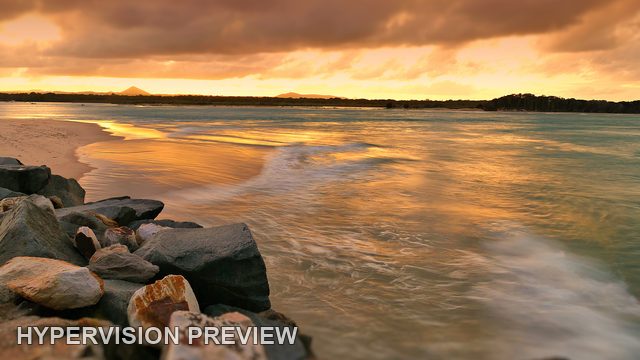 Rocky Shore Beneath Golden Clouds