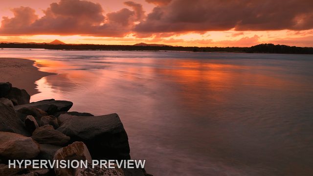 Pink and Orange Sky Above Shore Rocks