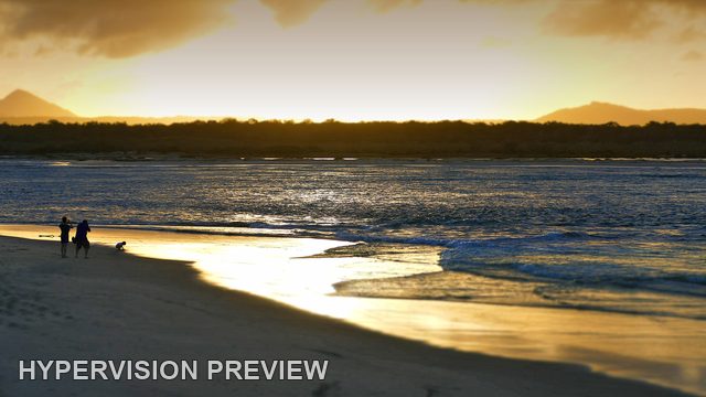 Small Figures Below a Stormy Sunset Sky