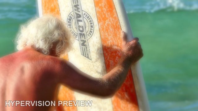 White-Haired Surfer Holding an Orange Board — Colour