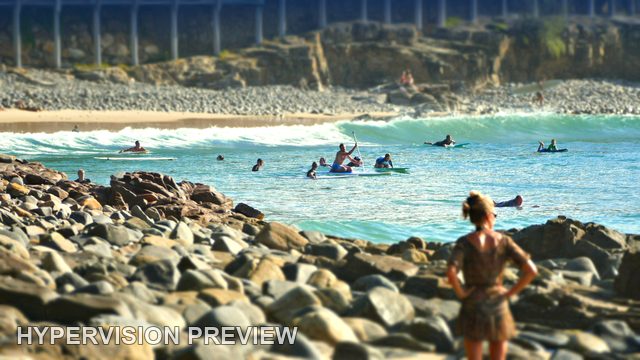 Watching Board Riders Beside a Rocky Cove — Colour