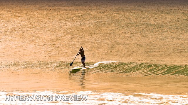 Stand-Up Paddleboarder on a Small Wave — Warm Colour