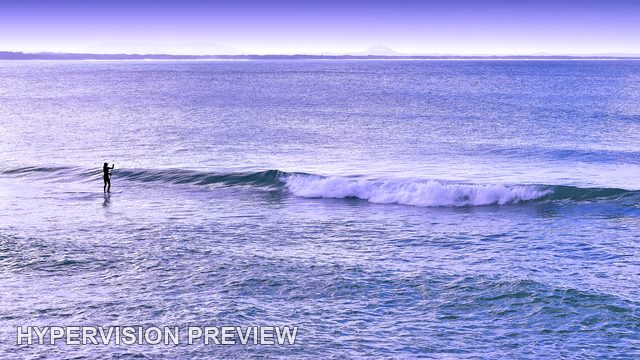 Paddleboarder Beside a Long Breaking Wave — Purple