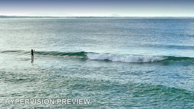 Paddleboarder Beside a Long Breaking Wave — Colour