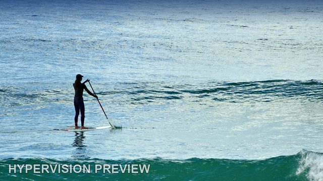 Paddleboard Silhouette on Shimmering Water — Colour