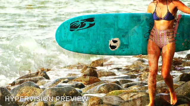 Turquoise Surfboard Beside Shoreline Rocks — Distressed Texture