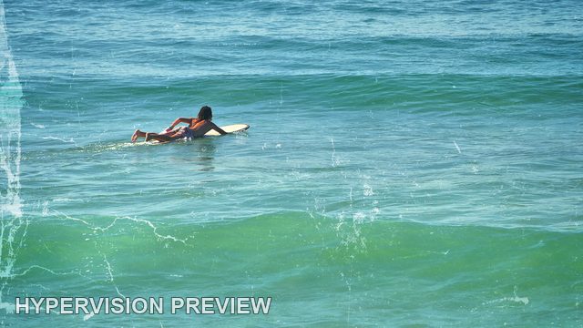 Surfer Paddling Towards an Incoming Swell — Distressed Blue