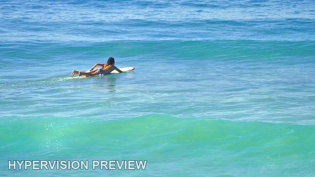 Surfer Paddling Towards an Incoming Swell — Colour