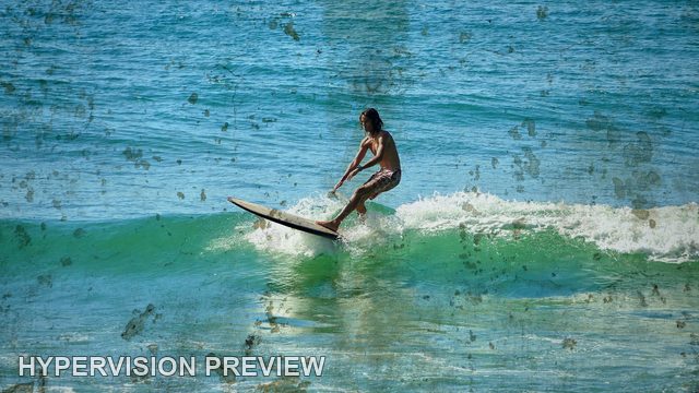 Longboard Rider Gliding Across a Green Wave — Distressed Texture