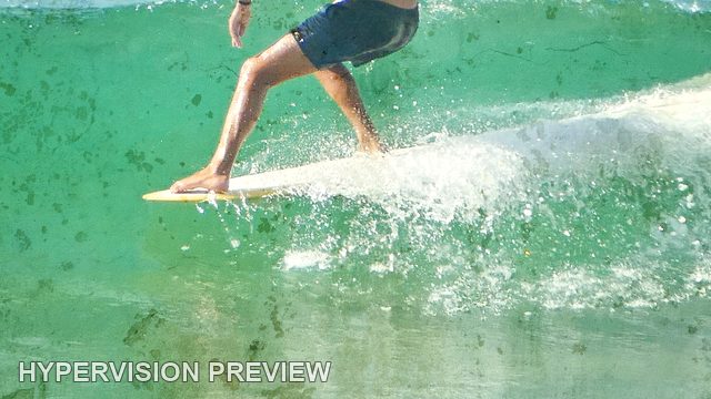Abstract of Surfboard and Legs Cutting Across a Green Wave — Speckled Texture Abstract