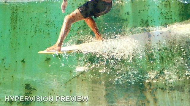 Abstract of Surfboard and Legs Cutting Across a Green Wave — Distressed Texture Abstract
