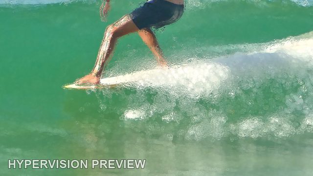 Surfboard and Legs Cutting Across a Green Wave — Soft Colour