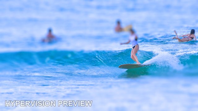 Longboarder with Surfers Waiting Beyond — Cool Blue / Selective Focus 01