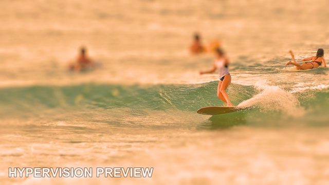 Longboarder with Surfers Waiting Beyond — Warm Colour / Selective Focus 01