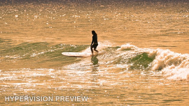 Silhouetted Longboarder on Sparkling Water — Warm Colour