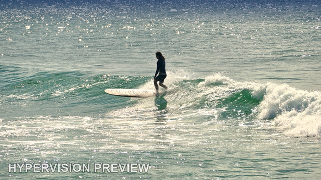 Silhouetted Longboarder on Sparkling Water — Colour