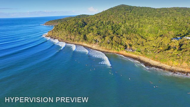 Aerial Surf Lines Around a Forested Headland — Colour