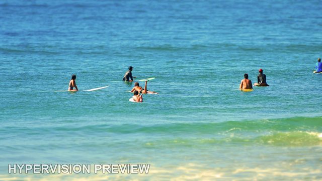 Surfers Waiting Together in Blue Water — Colour