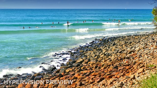 Surf Lineup Beyond a Broad Rocky Foreshore — Colour
