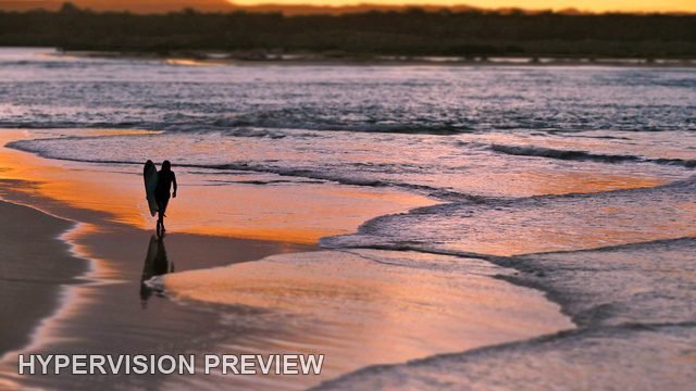 Lone Surfer on Reflective Sand at Sunset — Colour