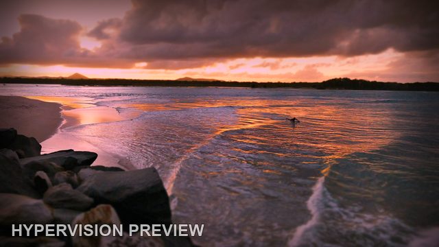 Surfer Beneath Dramatic Sunset Clouds — Colour