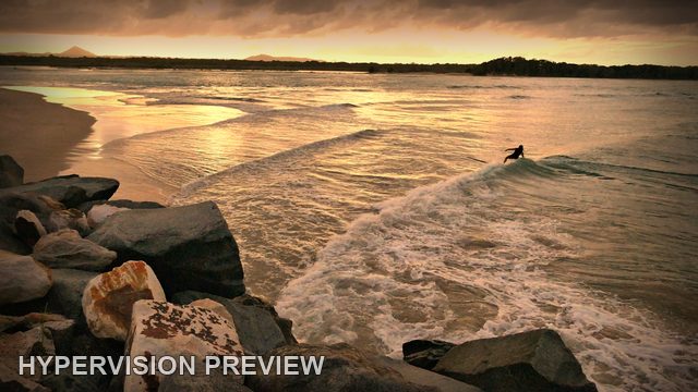 Lone Board Rider in Golden Shorebreak — Dark Vignette