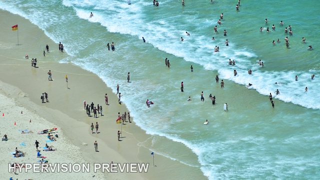 Gold Coast Beachgoers and Pale Green Surf