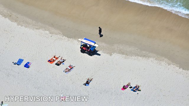 Colourful Towels and Beach Cart Beside the Waterline