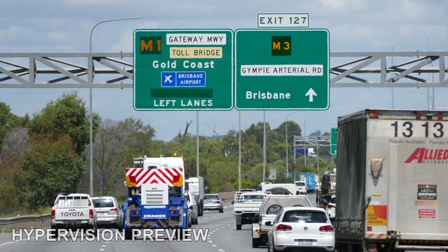 Emergency Vehicle Beneath Gateway Motorway Direction Signs