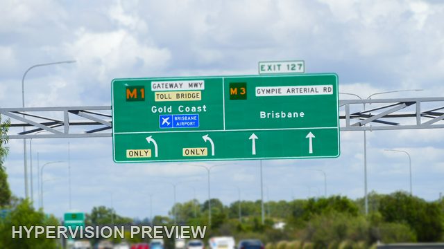 Exit 127 Signs Against a Cloudy Blue Sky