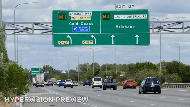 Motorway Lanes with Orange Car and Route Directions