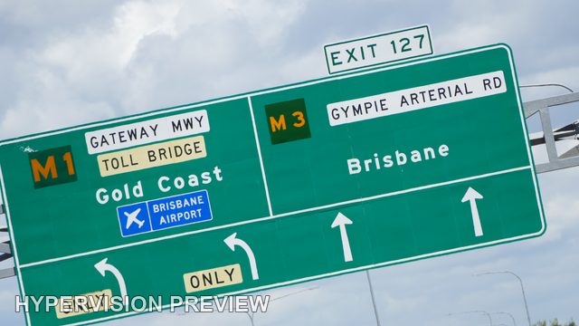 Tilted Exit 127 Sign for Brisbane and the Gold Coast