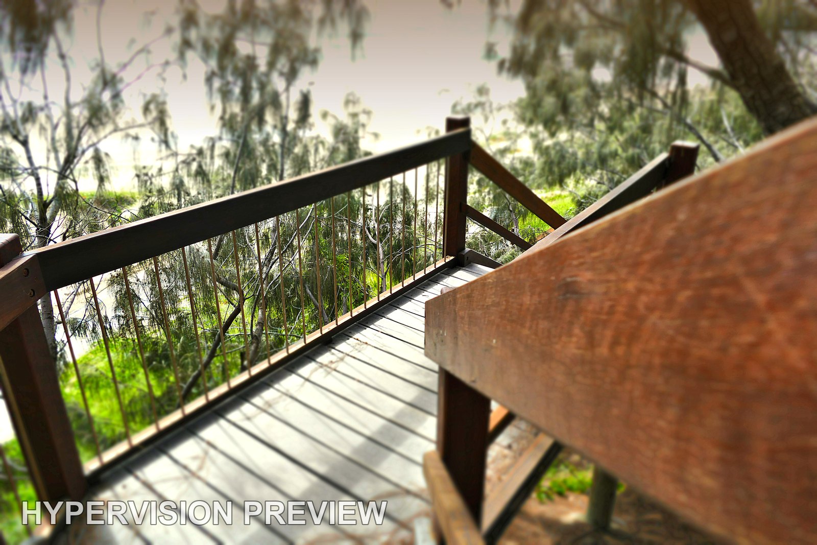 Close Timber Handrail above a Shaded Beach Landing
