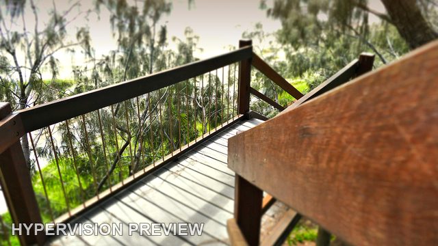 Close Timber Handrail above a Shaded Beach Landing