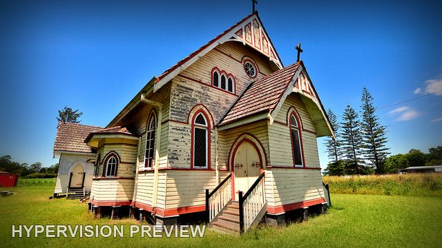 Timber Church with Red Trim beneath a Blue Sky