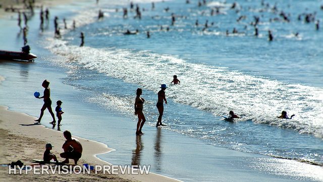 Swimmers and Walkers Along the Surf Line — Selective Focus Edit