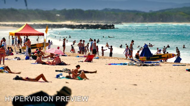 Sunbathers and a Red Beach Canopy