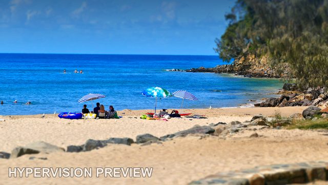 Quiet Beach Corner Beside a Wooded Headland