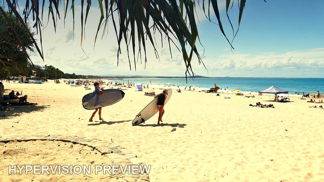 Surfers Carrying Boards Across the Sand — Sun-Warmed Edit