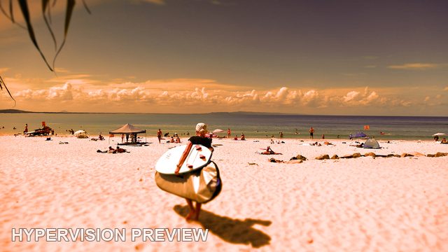 Surfer Carrying a Board Toward the Beach — Warm Edit