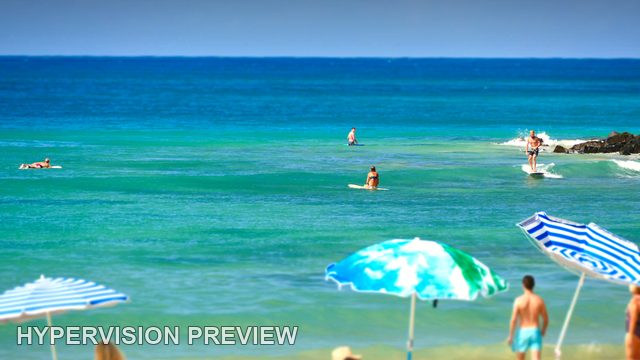 Striped Umbrellas Beside Turquoise Water